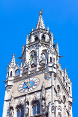 Fototapeta na wymiar Spire with horology of Munich Rathaus , Bavaria Germany . Top of New Town Hall in Munich