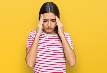 Young hispanic woman wearing casual clothes with hand on head for pain in head because stress. suffering migraine.