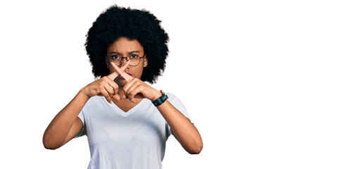 Fototapeta na wymiar Young african american woman wearing casual white t shirt rejection expression crossing fingers doing negative sign