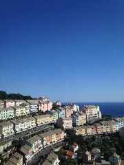 Genova mountain city with houses and the sea in the background