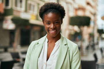 Young african american businesswoman smiling happy standing at the city