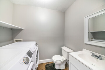 Interior of a small laundry room in the bathroom with vanity sink