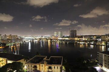 Fototapeta premium Golden Isles Lake, Hallandale Beach, Florida, USA. Night view for residential skyscrapers. 