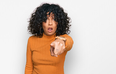 Young hispanic woman wearing casual clothes pointing displeased and frustrated to the camera, angry...