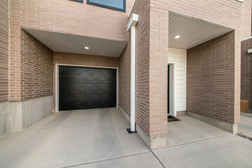 Townhouse garage exterior with smooth brown bricks