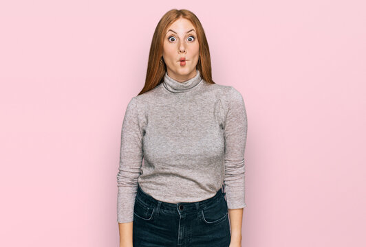 Young irish woman wearing casual clothes making fish face with lips, crazy and comical gesture. funny expression.