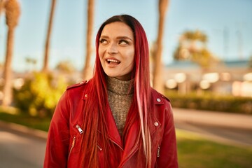 Young caucasian girl smiling happy standing at the city.