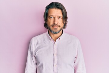 Middle age handsome man wearing business shirt with serious expression on face. simple and natural looking at the camera.