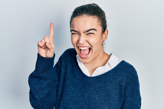 Young caucasian girl wearing casual clothes pointing finger up with successful idea. exited and happy. number one.