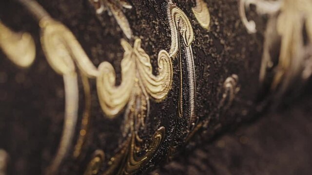 Rolls with wallpaper. Ornament close-up. Stand with wallpaper in the store