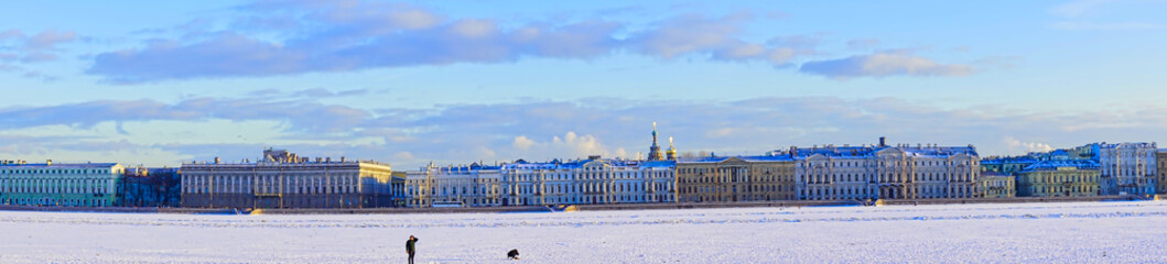Fototapeta na wymiar The Neva river in ice. Embankment of St. Petersburg with colorful neat buildings. Museums and architecture of St. Petersburg, Russia. Spring 2017.