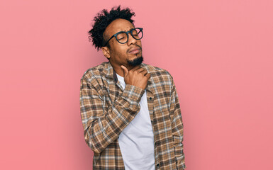 Young african american man with beard wearing casual clothes and glasses touching painful neck, sore throat for flu, clod and infection