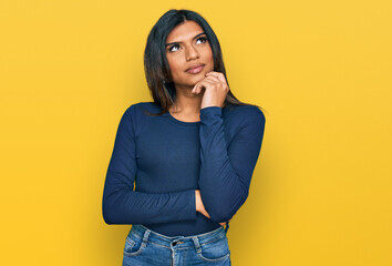 Young latin transsexual transgender woman wearing casual clothes serious face thinking about...