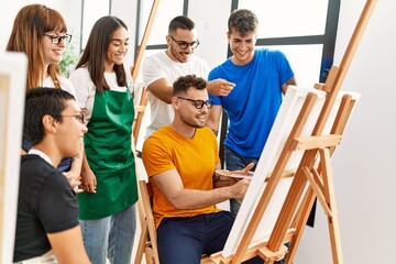 Group of people smiling happy and looking draw of partner at art studio.