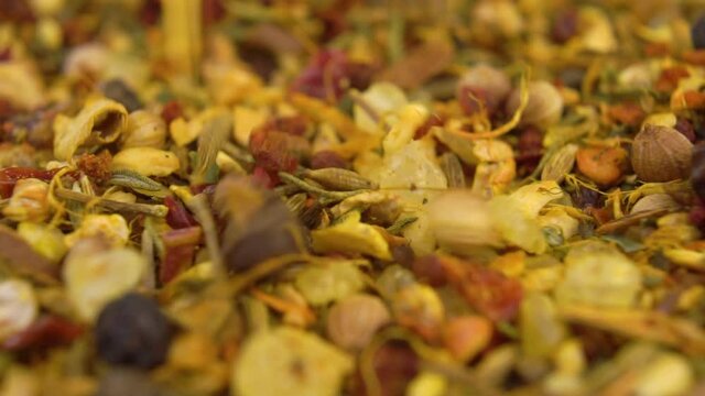 Spicy seasoning mix. Hot condiment. Falling seeds and herbs in slow motion. Macro shot.