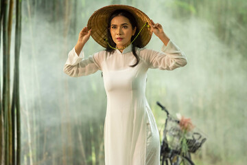 Portrait of a Vietnamese woman posing with a bicycle