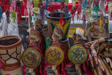 Aztec warrior idols with colorful headdress and shield