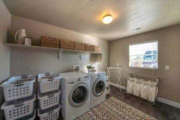 Spacious laundry room with window and lots of storage baskets