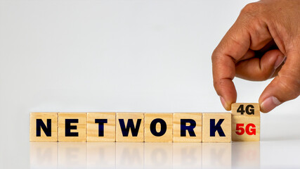 Hands are turning the cube of 4G numbers to 5G, the concept of 5G network and the connection of...