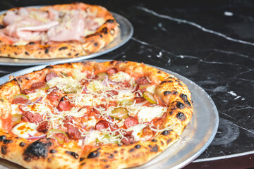 Fresh italian pizza. Served on black stone table. Traditional recipe, Italian cuisine concept.