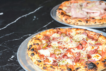 Fresh italian pizza. Served on black stone table. Traditional recipe, Italian cuisine concept.