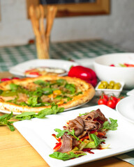Meat and vegetable salad with mushrooms, red pepper, red onion and fresh rosemary.