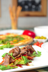 Meat and vegetable salad with mushrooms, red pepper, red onion and fresh rosemary.