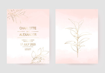 Delicate wedding invitation cards with gold leaf on pale pink watercolor texture.