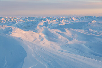 Winter arctic landscape. View of snow and ice at sunset. Ice hummocks on the frozen sea in the...