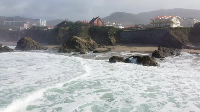 Aerial drone view of the beach of Bakio in the Basque Country in a foggy day