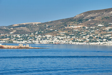 Fototapeta na wymiar Parikia, Greece - June 2017: Port and the town Parikia as seen from a ferry during the loading of the ship, Paros island in Greece, Europe