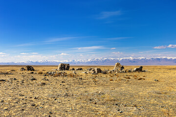 Fototapeta na wymiar Tarkhatinsky megalithic complex consists of stone blocks. Archaeological monument in Chui steppe, Altai Republic, Russia