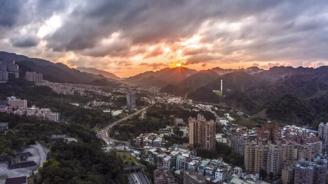 Cinematic hyperlapse drone flight over large metropolis with skyscraper buildings and traffic on road. Xindian ankeng district, New Taipei City, Taiwan 