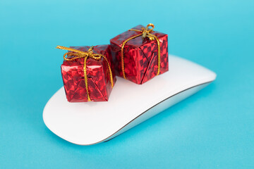 Two gift boxes on mouse on blue background