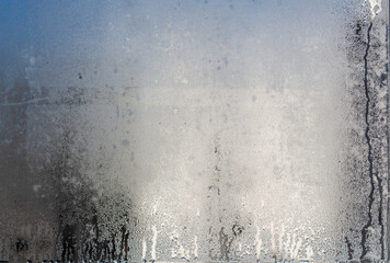 haze and droplets generated by the cold on the window glass reflected by the morning sun