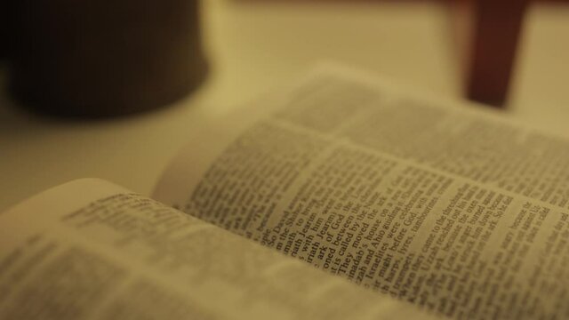 close up of an open bible book on shelf