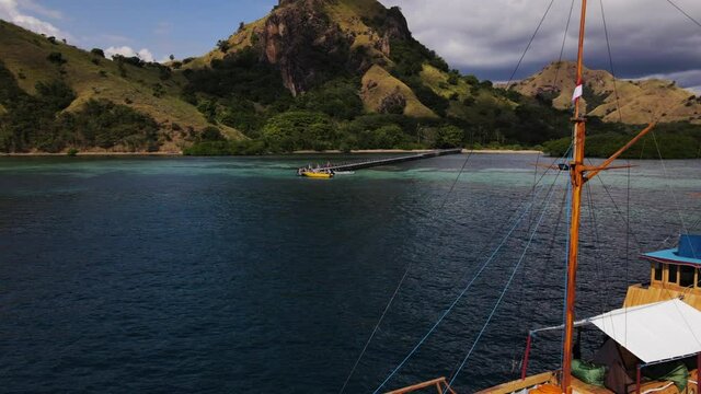 Aerial View Of A Wooden Boat At The Blue Waterscape Of Flores Sea With Coastal Hills At Komodo. East Indonesia.