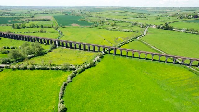 Aerial View Of Welland Viaduct Over Green Fields At Daytime In Seaton, England.