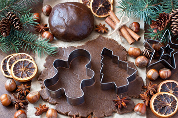 Cookie cutter in form of gingerbread man in rolled out dough