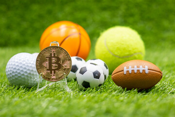 Bitcoin with soccer ball are on green grass for betting concept with sport