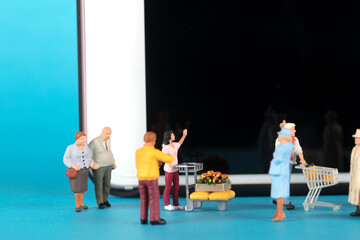 Various doll models in front of the phone screen