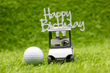 Golf ball With Happy Birthday sign are on green grass background