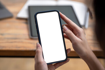 Close-up of woman using a smartphone blank white screen at the office.