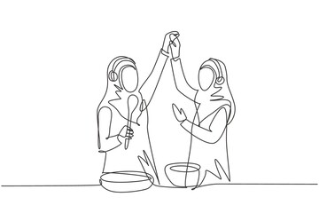 Continuous one line drawing two Arabian woman smiling and dancing with frying pan and spatula in hand while cooking together in kitchen at home. Single line draw design vector graphic illustration