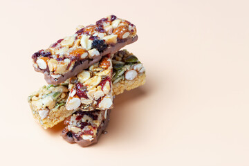 Stack of protein bars close-up on brown background copy space.