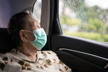 Very old Asian woman age between 80 -90 years old travel by the personal car,.