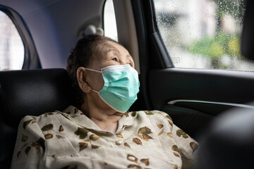 Very old Asian woman age between 80 -90 years old travel by the personal car.