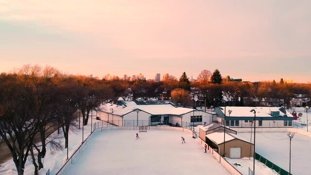 Classic Canadian Outdoor Hockey Rink at Sunset