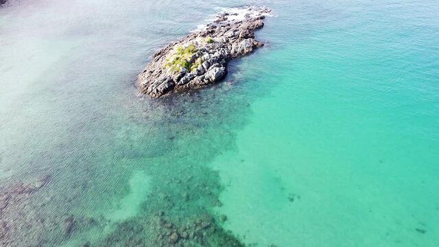 Aerial drone of deep green ocean and rocky outcrop in Maitai Bay, Karikari Peninsula, Northland, New Zealand Aotearoa