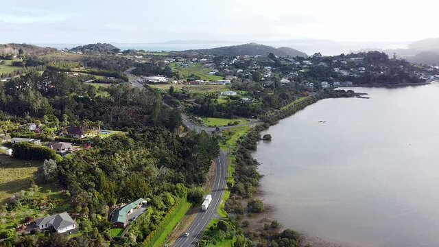 The historic town of Mangonui in Northland, New Zealand, Aotearoa with traffic arriving and leaving aerial drone